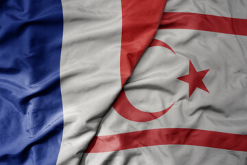 big waving realistic national colorful flag of france and national flag of northern cyprus .