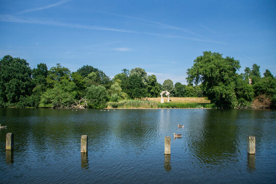 The Arch Statue On The Shores Of The Serpentine Lake In Hyde Park. Duck Swimming In The Water. London, United Kingdom.