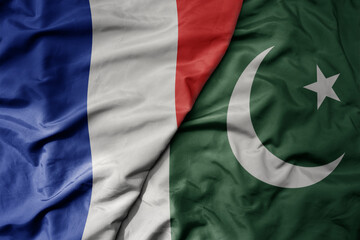 Fototapeta premium big waving realistic national colorful flag of france and national flag of pakistan .