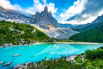 Naklejka na ściany i meble Beautiful view on turquoise Sorapis lake and with dito di dio in the background in the evening. Lake Sorapis, Dolomites, Belluno, Italy, Europe.