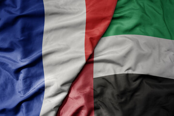 Obraz premium big waving realistic national colorful flag of france and national flag of united arab emirates .