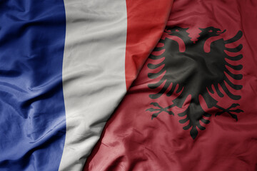 big waving realistic national colorful flag of france and national flag of albania .