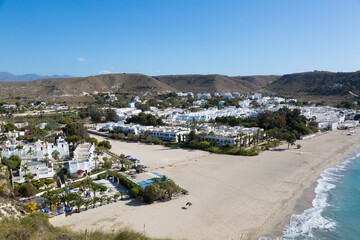 Beach of fine sand and waves, choppy seas