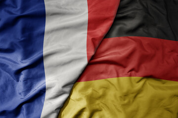 big waving realistic national colorful flag of france and national flag of germany .