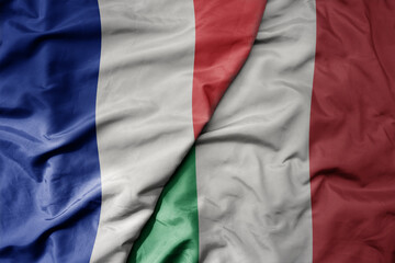 big waving realistic national colorful flag of france and national flag of italy .