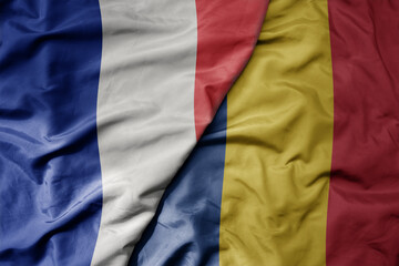 big waving realistic national colorful flag of france and national flag of romania .