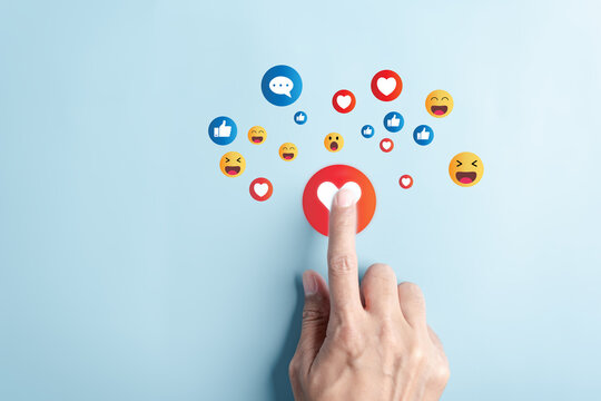 Social media and digital online, Hand finger touching Love button emoticon, Social media. concept of living on vacation and playing social media. online marketing, technology network connection global