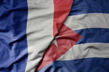 big waving realistic national colorful flag of france and national flag of cuba .