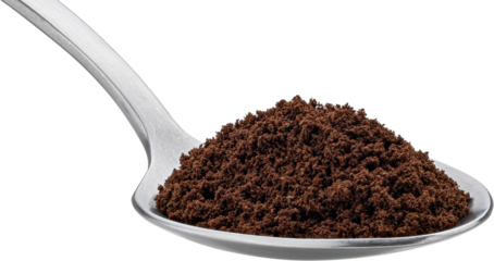 Ground coffee beans in spoon isolated