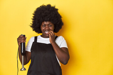 Home-baking woman with mixer, ready to create biting fingernails, nervous and very anxious.