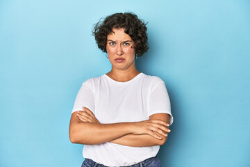 Young Caucasian woman with short hair unhappy looking in camera with sarcastic expression.