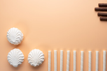 Background with marshmallows and black and white cream tubes