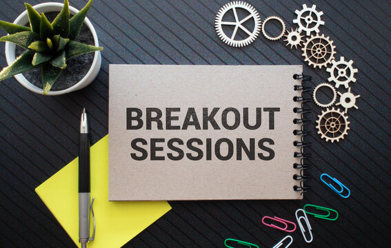 BREAKOUT SESSIONS - words on white sheet on a black leather book with pen. Business concept
