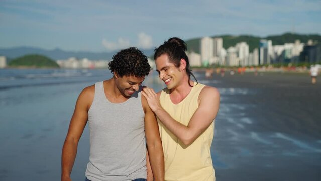 Summer love. An LGBTQ couple have a romantic moment walking on the beach with each other. Love and romantic moment.
