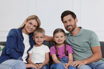 Obraz premium Portrait of happy family with children on sofa at home