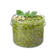 Jar with delicious pesto sauce, pine nuts and basil leaves isolated on white