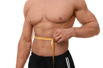 Athletic man measuring waist with tape on white background, closeup. Weight loss concept