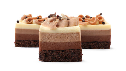 Pieces of triple chocolate mousse cake on white background