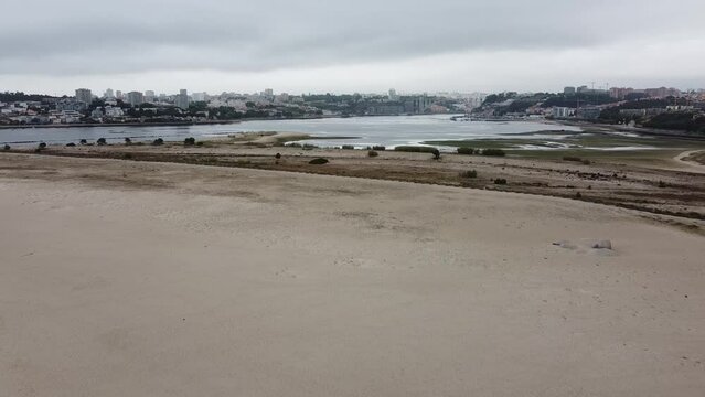 Aerial view over the Douro Estuary Local Nature Reserve, with the city of Porto in the background. Afurada, Vila Nova de Gaia - Portugal, 2023
