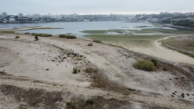 Aerial view over the Douro Estuary Local Nature Reserve, with the city of Porto in the background. Afurada, Vila Nova de Gaia - Portugal, 2023