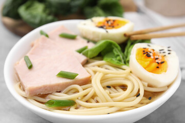 Delicious ramen with meat on table, closeup. Noodle soup