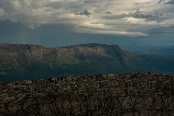 Fototapeta premium View south from Smaltinden of Brensla, Stockatinden, Hammaröyfjellet and syv søstre in the background. Afternoon hiking in Northern Norway, summer. Fjelltur i Helgeland. Archipelago Norwegian sea. 