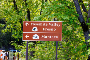 Direction sign to Yosemite Valley, Fresno, and Manteca from El Portal Road in Yosemite National Park
