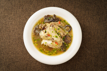 Special Chinese food stewed chicken with mushrooms on retro dark background