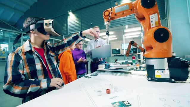 A kid is managing a robotic device using virtual reality technology