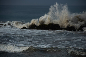 Waves crashing against rocks on the seashore