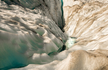Fototapeta premium Flying by helicopter to the glacier and then Heli hiking on the glacier floor high up in the Southern Alps mountain peaks on Fox Glacier