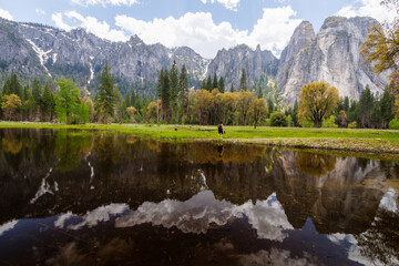 View of Mountains reflecting on flood water pond from Northside Drive in Yosemite Valley, Yosemite National Park, California, USA in May of 2023
