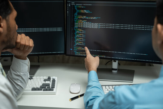 IT programmer working on desktop computer Male expert innovating software engineer app development program check coding in bugging system.