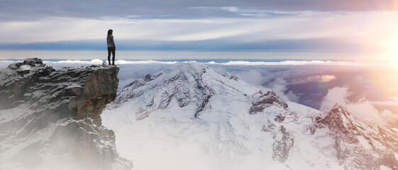 Epic Adventure Composite of woman Hiker on top of a rocky mountain.