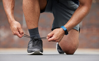 Person hands, sports and tie shoes for running workout, training and action performance on ground...