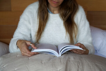 Woman Reading in Bed by Candlelight. A cozy and peaceful scene, capturing the joy of reading before...