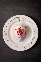 Chiles en Nogada, Typical dish from Mexico. Prepared with poblano chili stuffed with meat and fruits and covered with a walnut sauce. Named as the quintessential Mexican dish for national holidays.