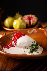 Chiles en Nogada, Typical dish from Mexico. Prepared with poblano chili stuffed with meat and fruits and covered with a walnut sauce. Named as the quintessential Mexican dish for national holidays.