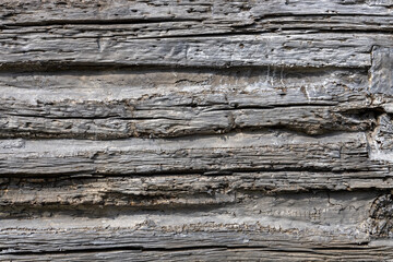 Full frame abstract texture background of a weathered exterior wall of a 19th century wooden log cabin