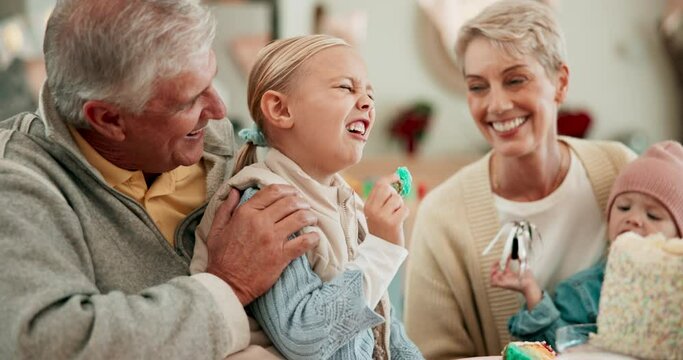 Grandparents, children and birthday party in family home, together and talking with hug, kiss and care. Senior man, woman and young kids with candy, love and celebration in house with playful laugh