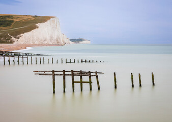 High tide at Cuckmere Haven and the cliffs of the Seven Sisters on the east Sussex coast, south east England UK