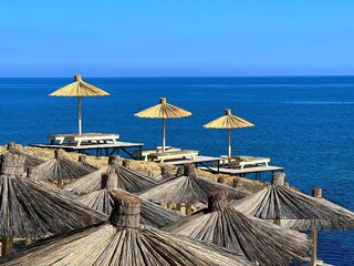 Beach umbrellas and blue ocean water.