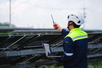 Engineer for quality control of solar panels in a power plant. Workers work in a solar power plant. 