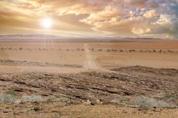 Namibia, panorama of the Namib desert, wild landscape with a dirt road in background

