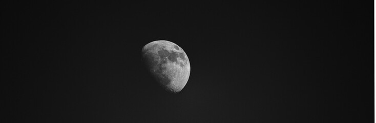 Black and white Panoramic image of the moon in the night sky