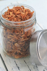 Fried onions in a jar on the table