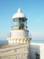 while lighthouse by ocean