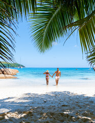 Fototapeta na wymiar Anse Lazio Praslin Seychelles is a young couple of men and women on a tropical beach during a luxury vacation there. Tropical beach Anse Lazio Praslin Seychelles Islands