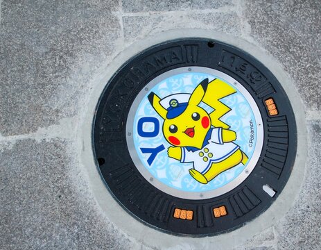 Yokohama, Japan - August 6 , 2019 - Manhole cover in Yokohama with a Pok&eacute;mon illustration, Pikachu wearing a sailor outfit. The manhole cover was installed for the Pikachu Outbreak event.