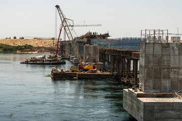 Fototapeta na wymiar Build of new Nile river Bridge after Luxor in direction Assuan during boat cruise construction site